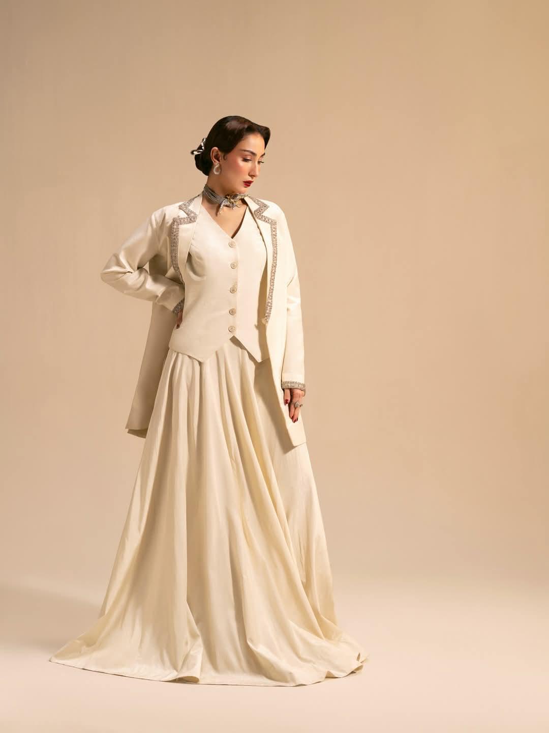 Woman wearing ivory formal maxi dress with structured embellished jacket, elegant modest luxury outfit for weddings and events